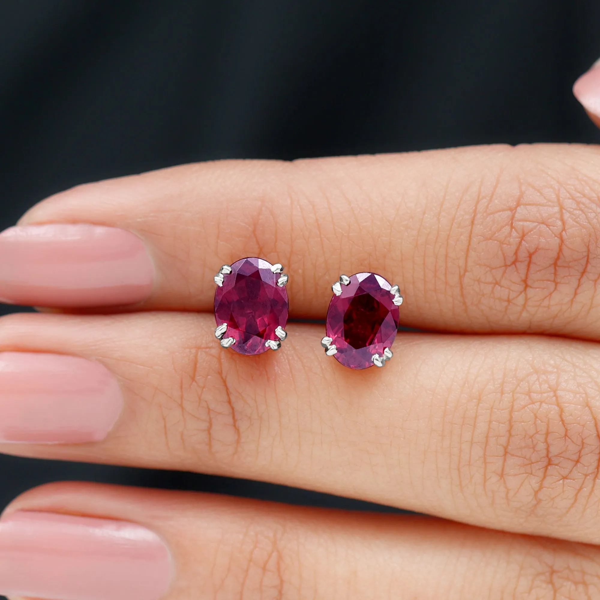 Oval Cut Rhodolite Solitaire Stud Earrings in Double Claw Setting