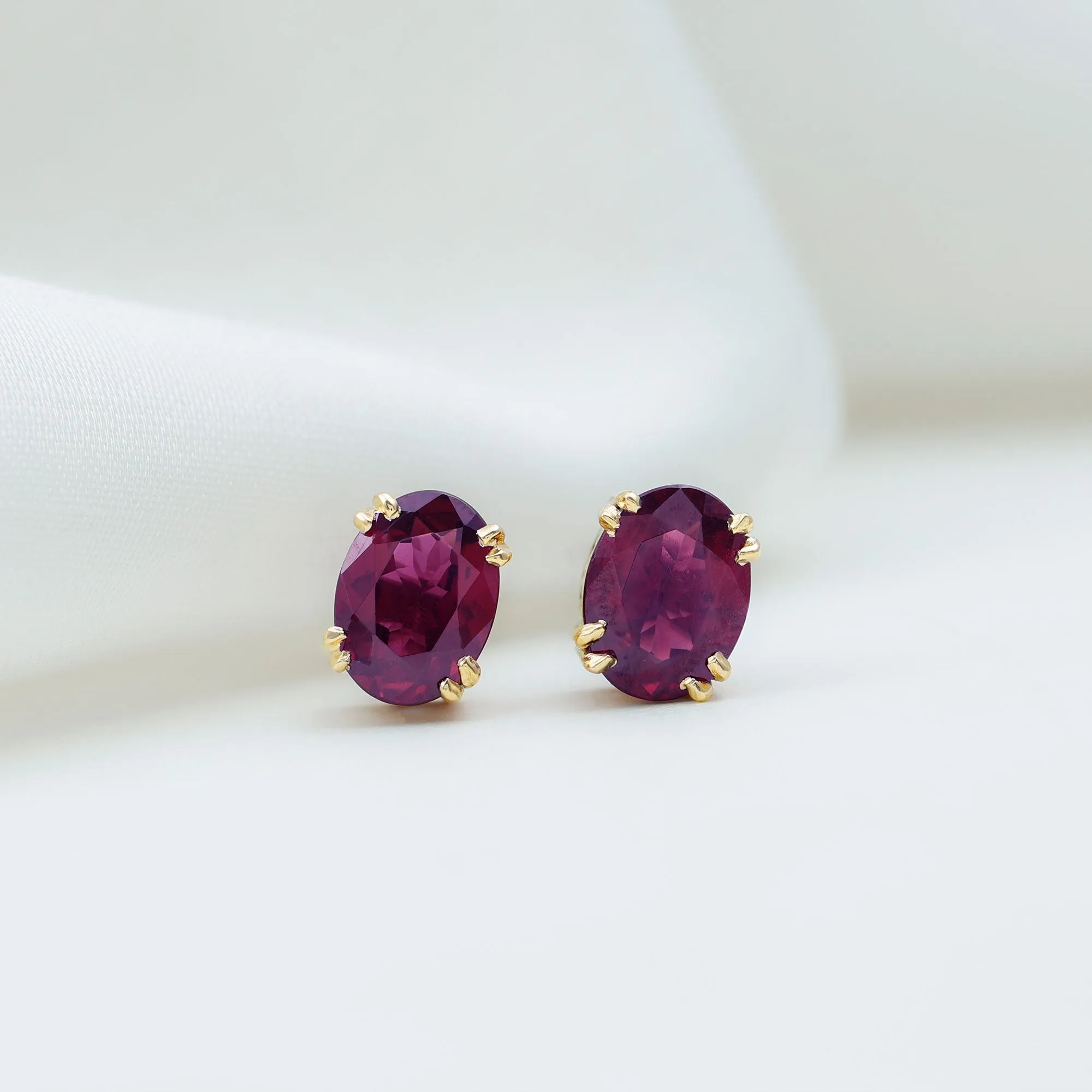 Oval Cut Rhodolite Solitaire Stud Earrings in Double Claw Setting