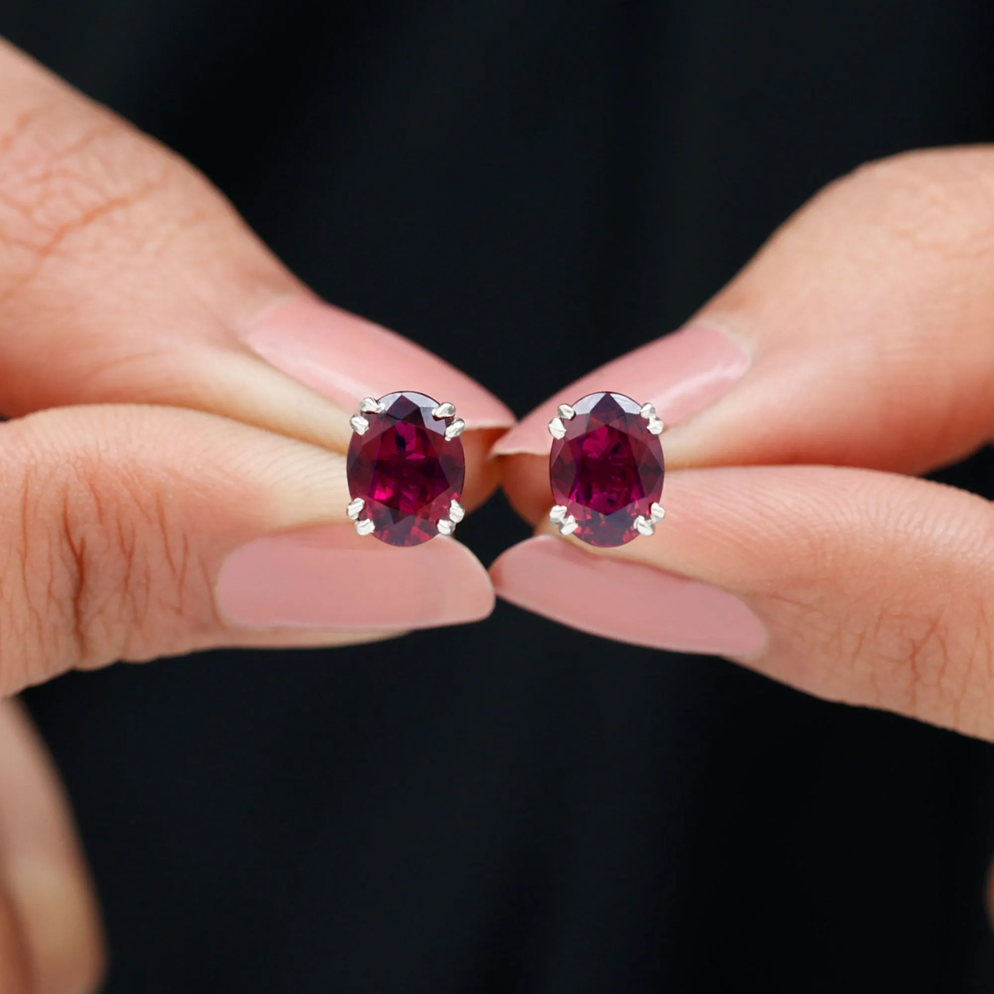 Oval Cut Rhodolite Solitaire Stud Earrings in Double Claw Setting
